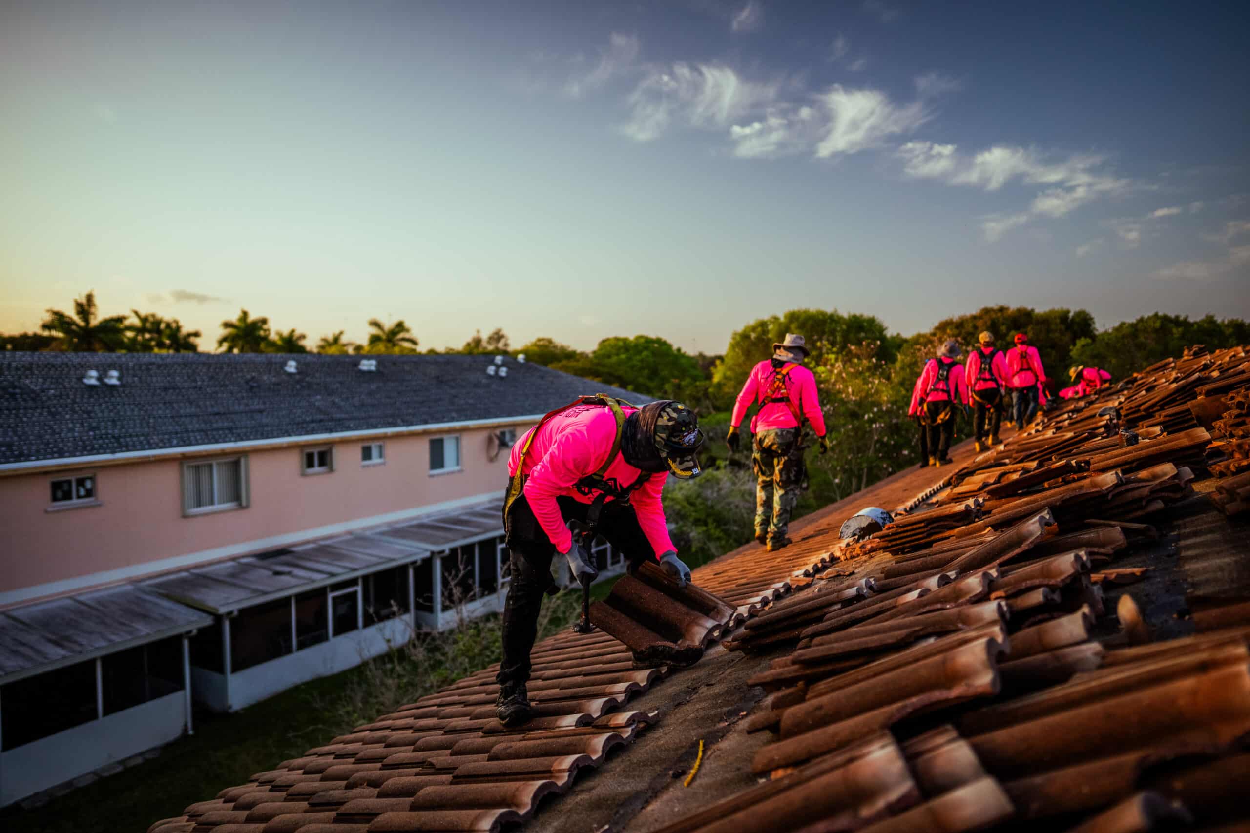 Men working on a roof installation at a residential home.