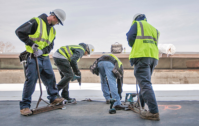 Specialists from Lake Erie Roofing and Construction completing a flat roof repair.